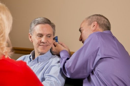 audiologist examining ear