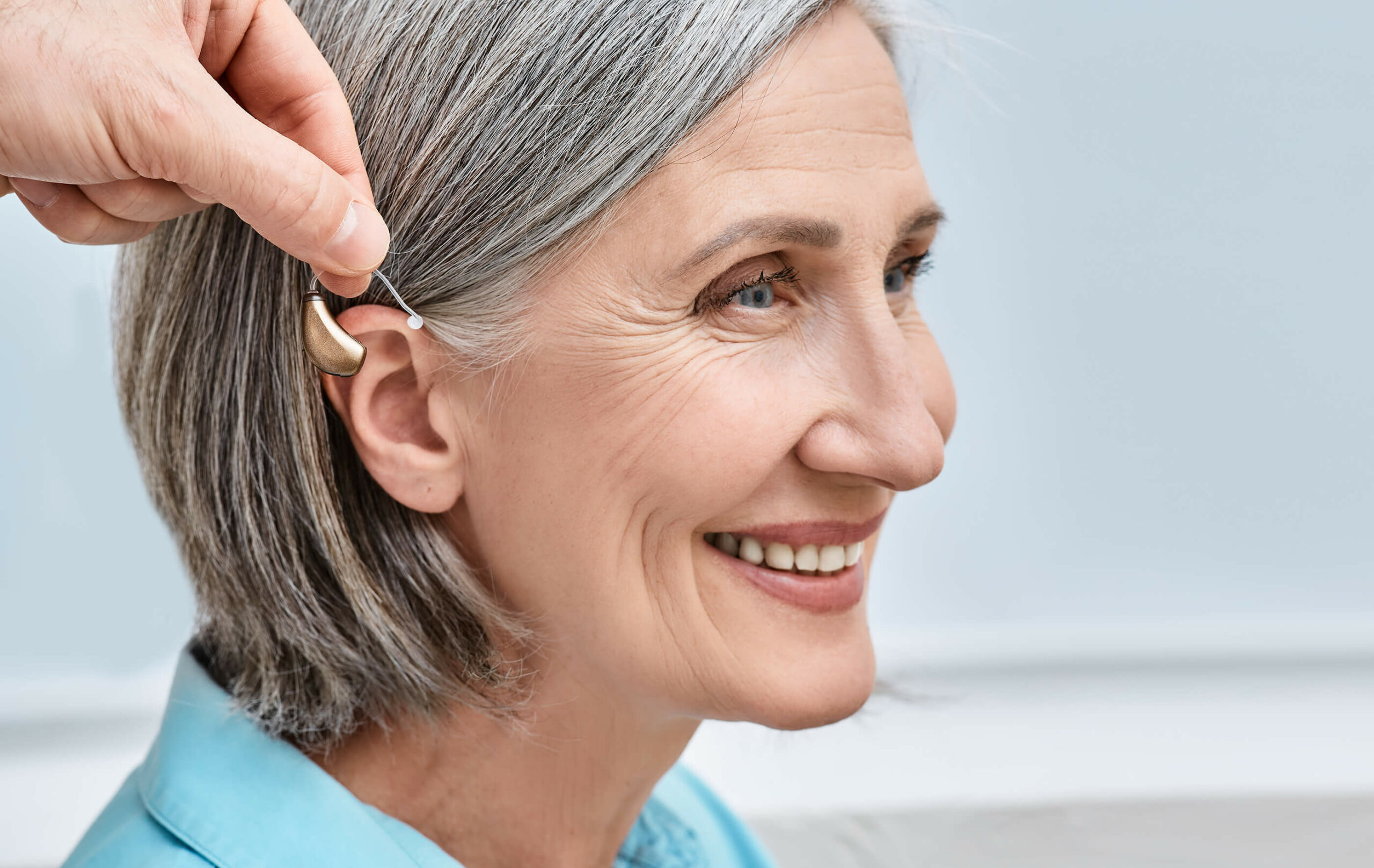 woman getting hearing aid fitted